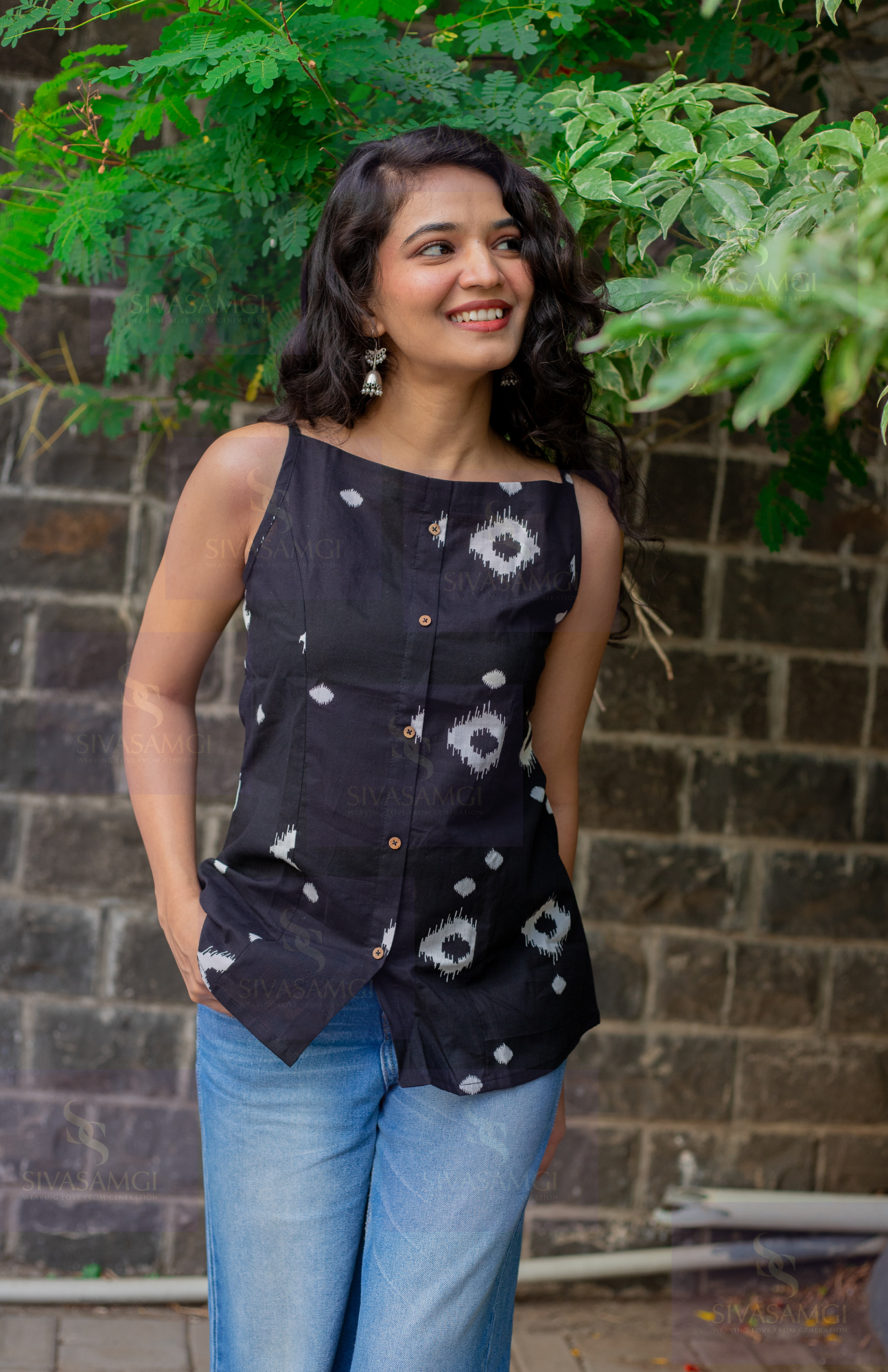 Women's black cotton noodle strap top styled with jeans