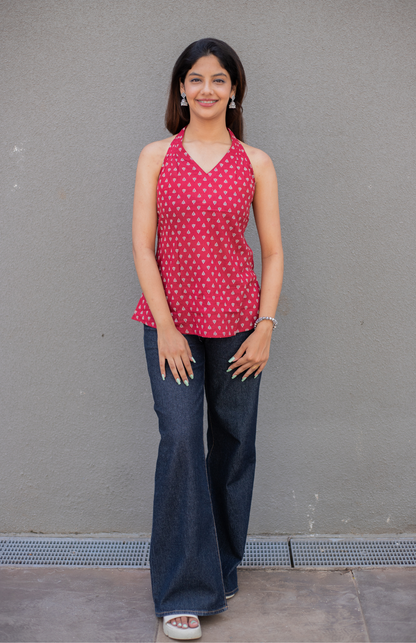 Woman wearing a red lotus small print top and blue jeans
