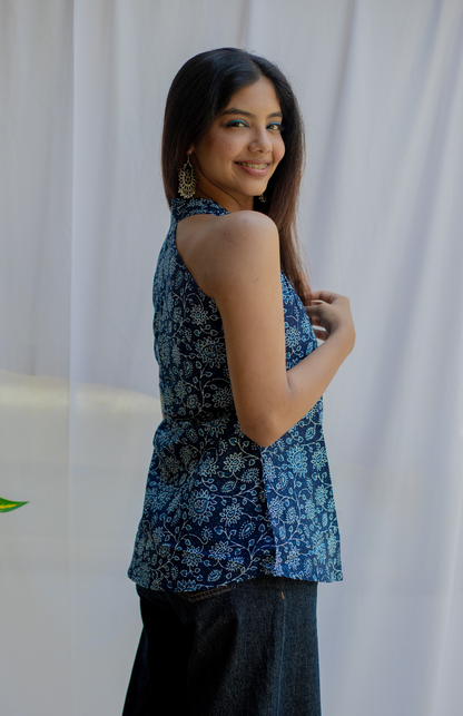 Woman wearing a blue floral sleeveless top 