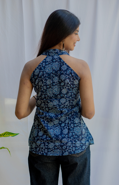 Woman wearing a blue floral sleeveless top 